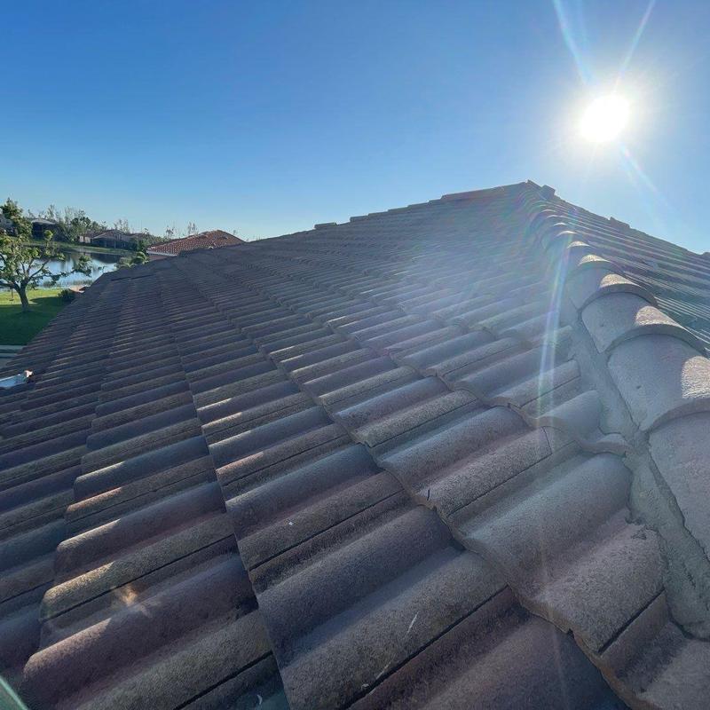 Concrete tile roof with ridge line and sunlight glare
