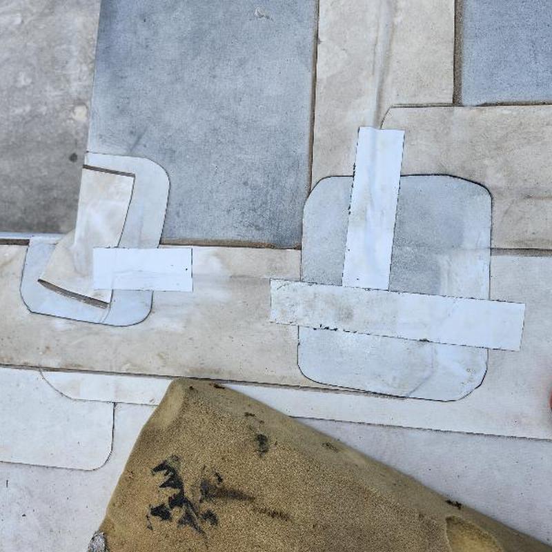 TPO roof patches covering holes on flat roof surface