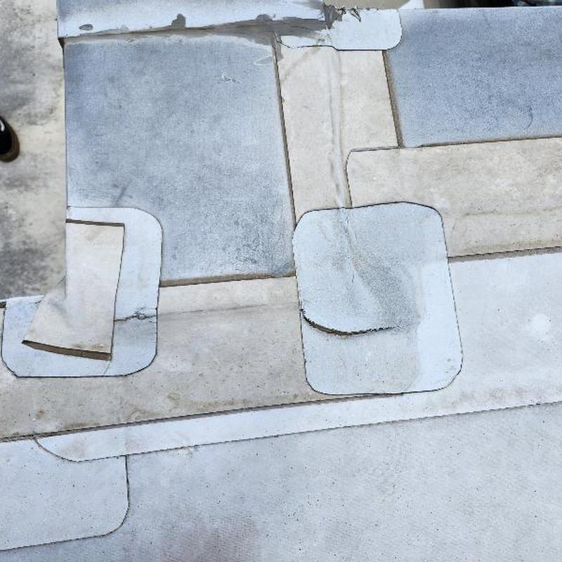 TPO roofing patches covering holes on flat roof