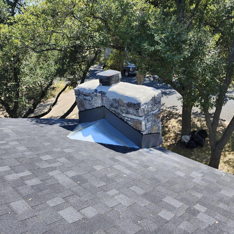 Chimney cricket and flashing installation on shingle roof