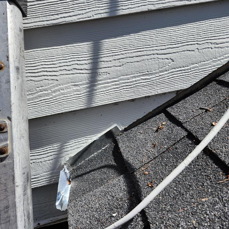 Chimney cricket and flashing installation on asphalt roof