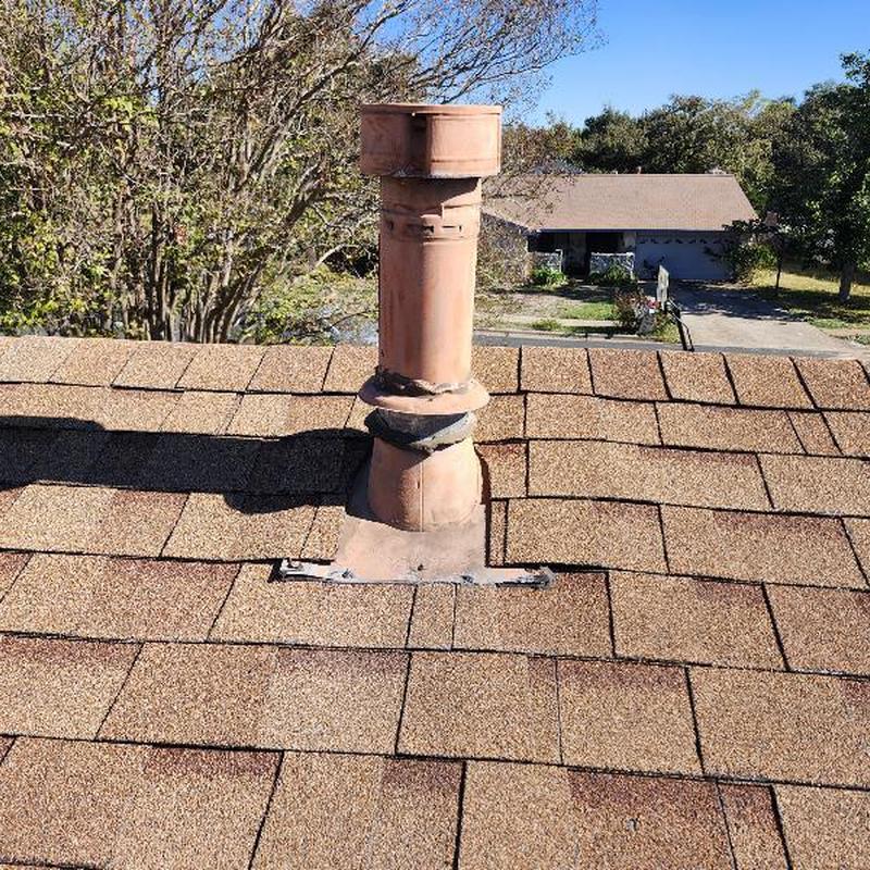 Water heater vent pipe with adjusted bent cap on roof