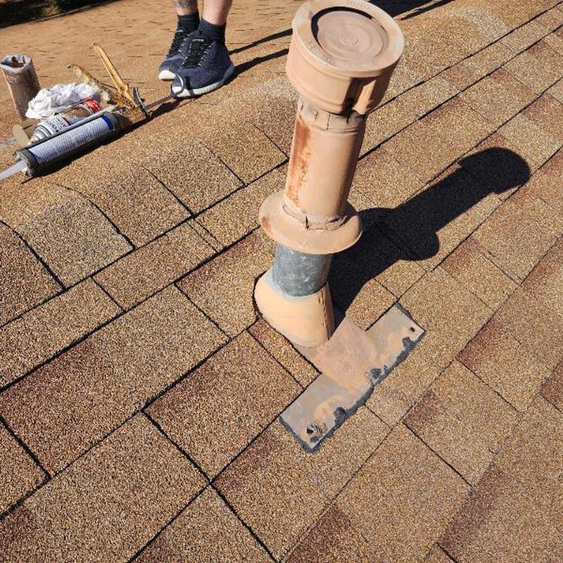 Roof vent pipe with rain collar on asphalt shingles