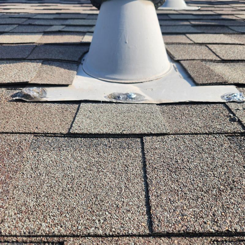Roof vent flashing with sealed exposed fasteners on shingles