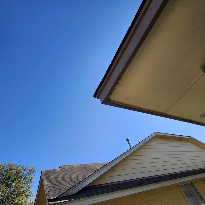 Asphalt shingle roof with tree damage and sealing work