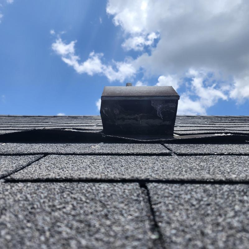 Roof shingles lifting near vent flashing on roof