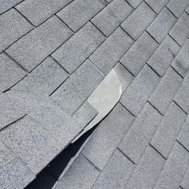 Roof valley flashing with newly attached metal piece