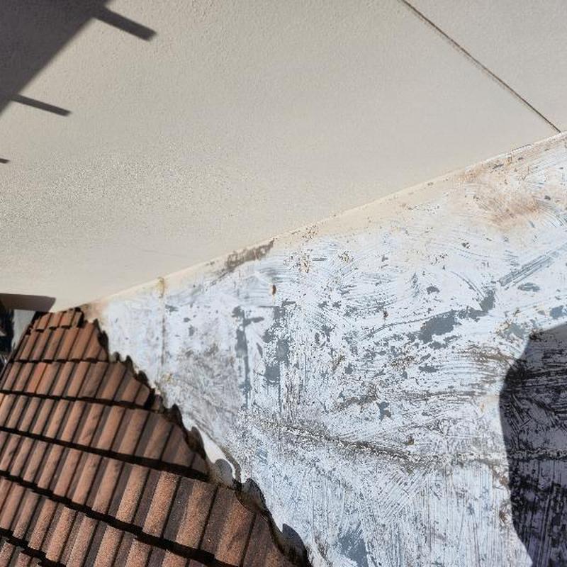 Clay tile roof and painted valley metal close-up view