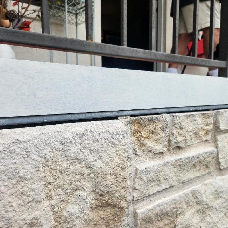 Standing seam roof flashing gap at stone wall