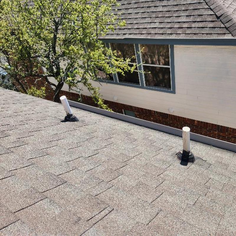 GAF Weather Gray hip shingles with vent pipes