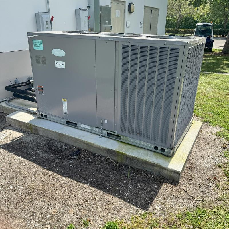 Commercial HVAC unit installed on concrete pad outdoors Commercial HVAC unit installed on concrete pad outdoors