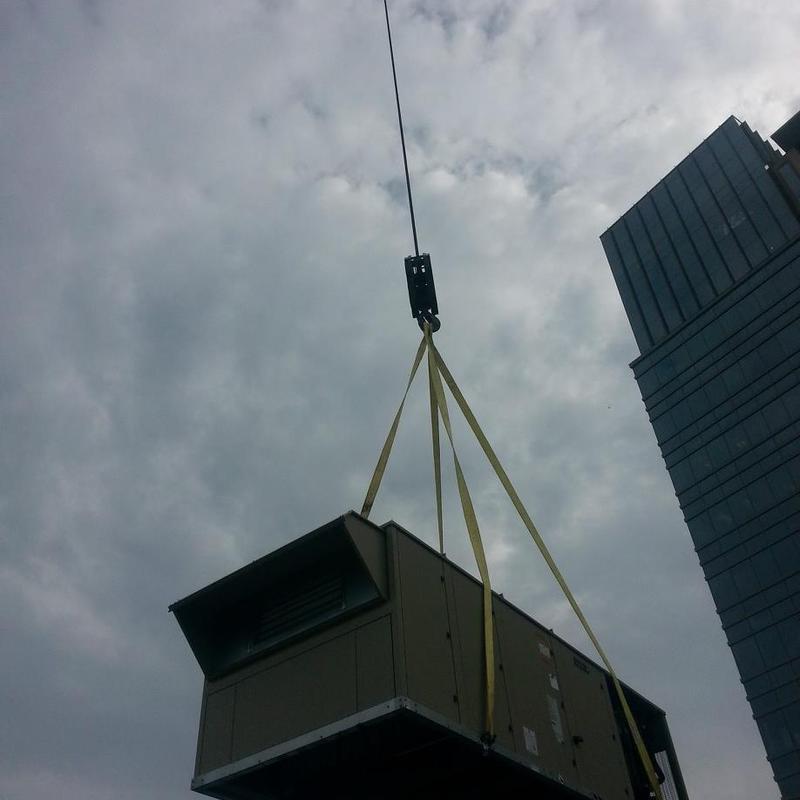 Commercial rooftop HVAC unit hoisted by crane Commercial rooftop HVAC unit hoisted by crane