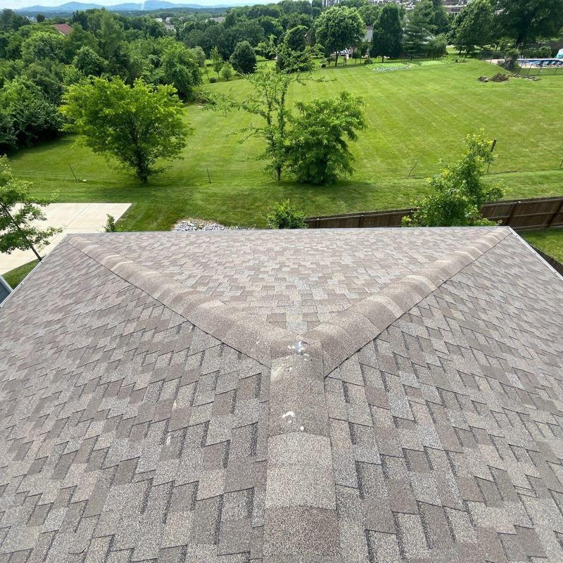 Roof shingles with hail damage near ridge vent