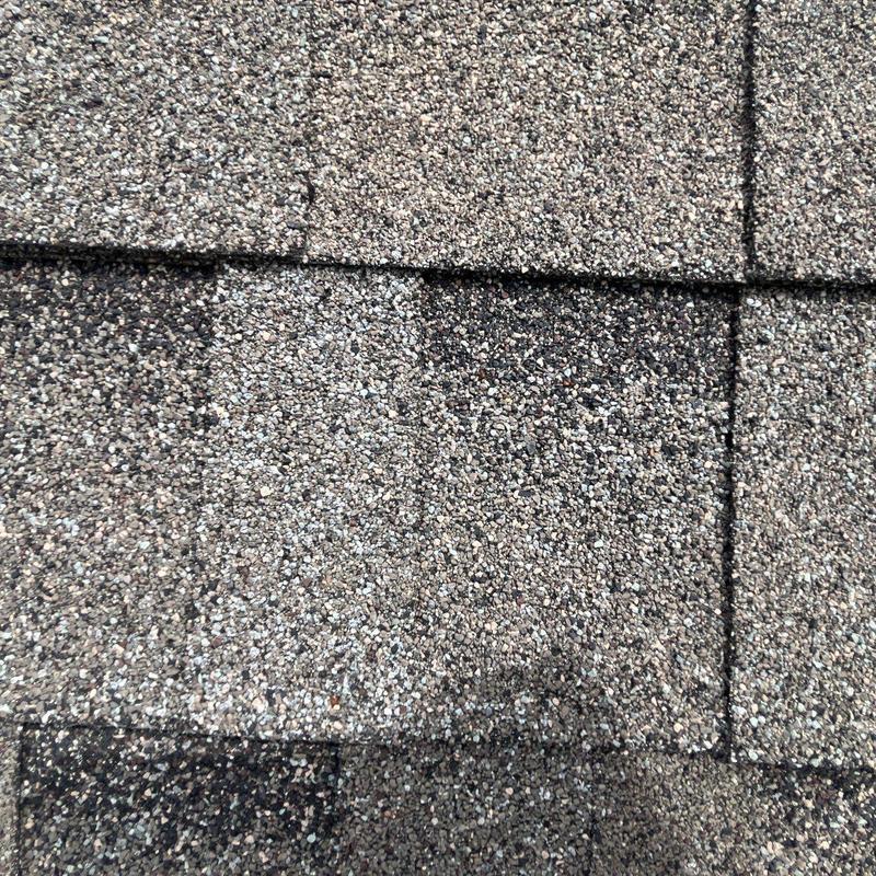 Roof shingles with hail damage and missing granules