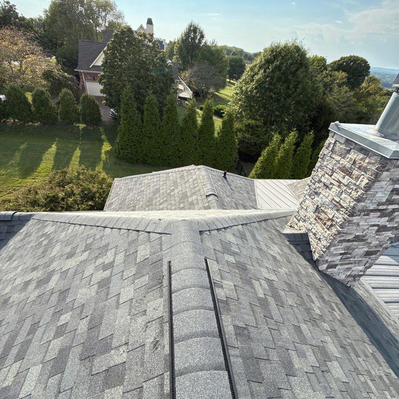 Asphalt shingle roof with chimney and ridge vent inspection