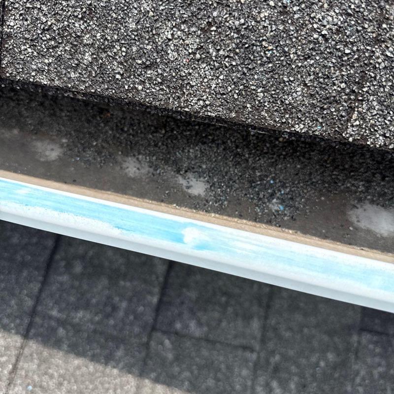 Asphalt shingle roof with hail damage and gutter edge