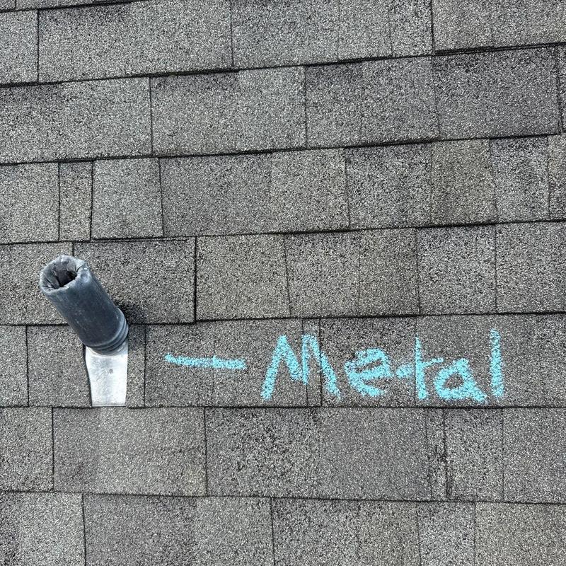 Asphalt shingle roof with vent pipe and metal flashing