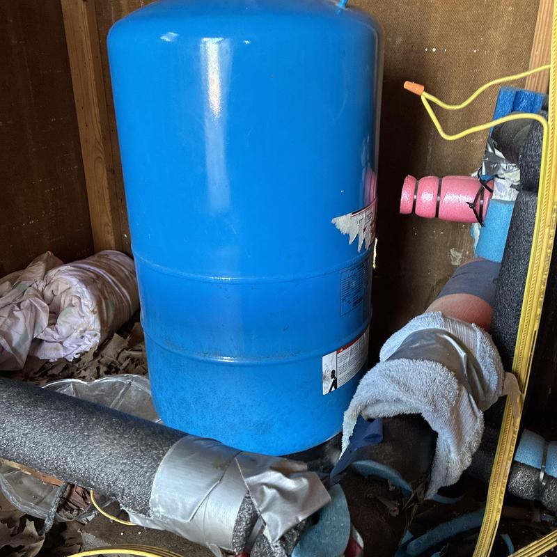 Pressure tank with insulation and plumbing connections