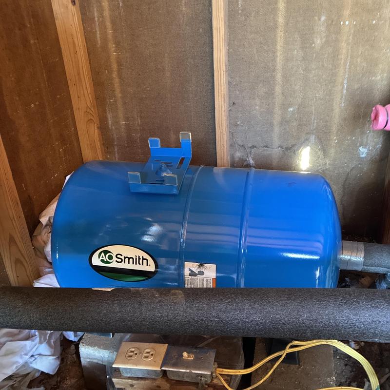 Pressure tank in well house with piping insulation