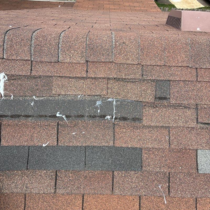 Asphalt shingle roof with hail damage and sealant marks