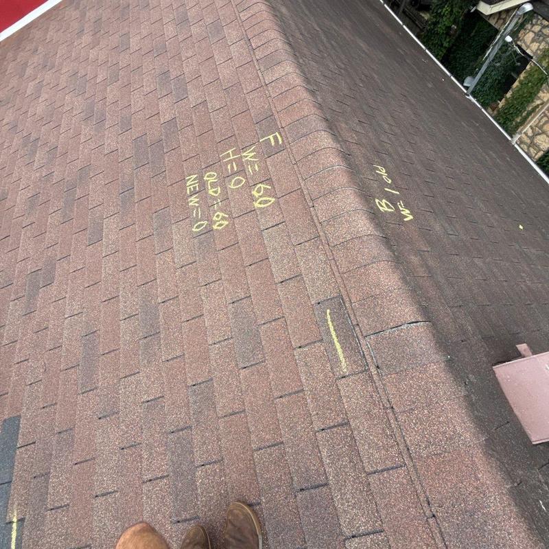 Roof shingles with yellow chalk markings for hail damage