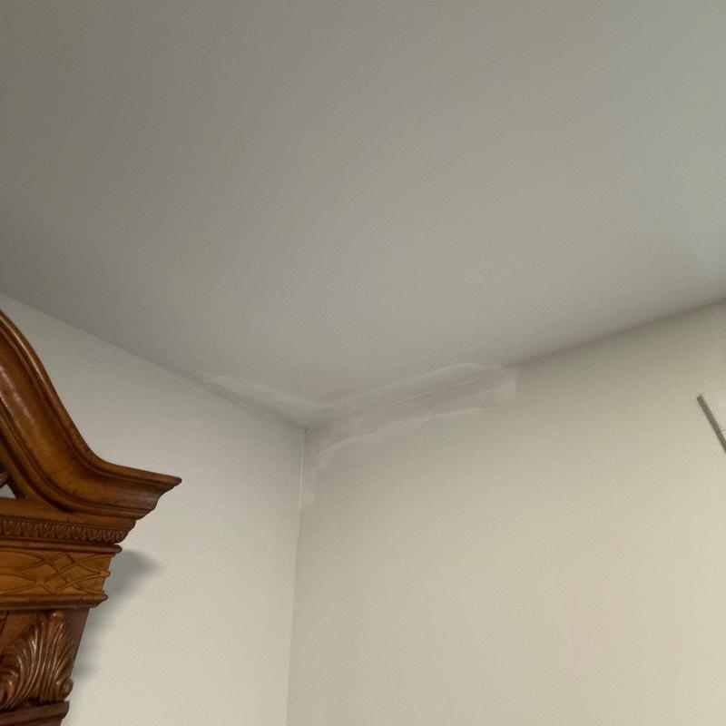 Ceiling corner with water damage and patch repair
