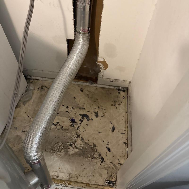 Dryer vent duct with damaged flooring and wall hole