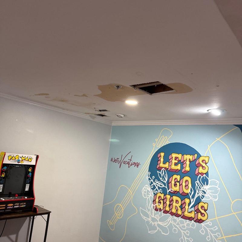 Ceiling water damage with light fixture and hole