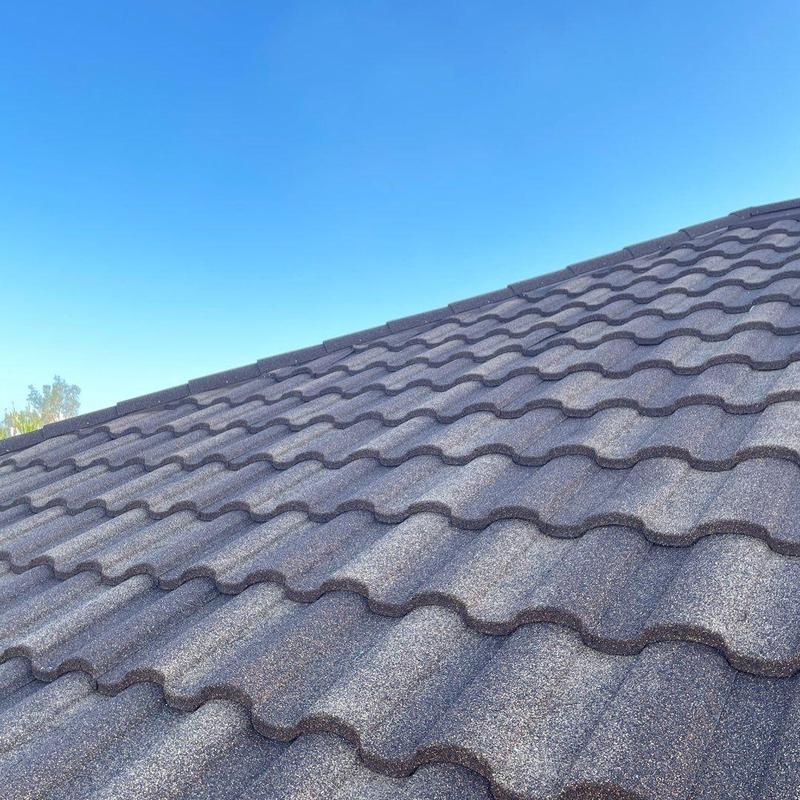 Stonecoated steel roof tiles under clear sky