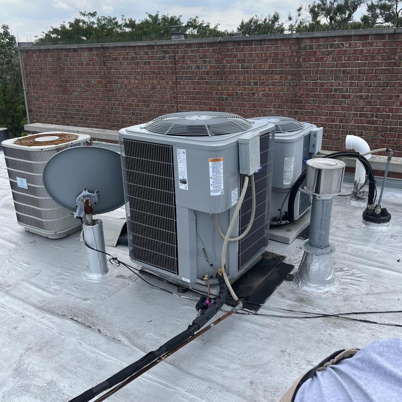 Air conditioner units on commercial rooftop with wiring