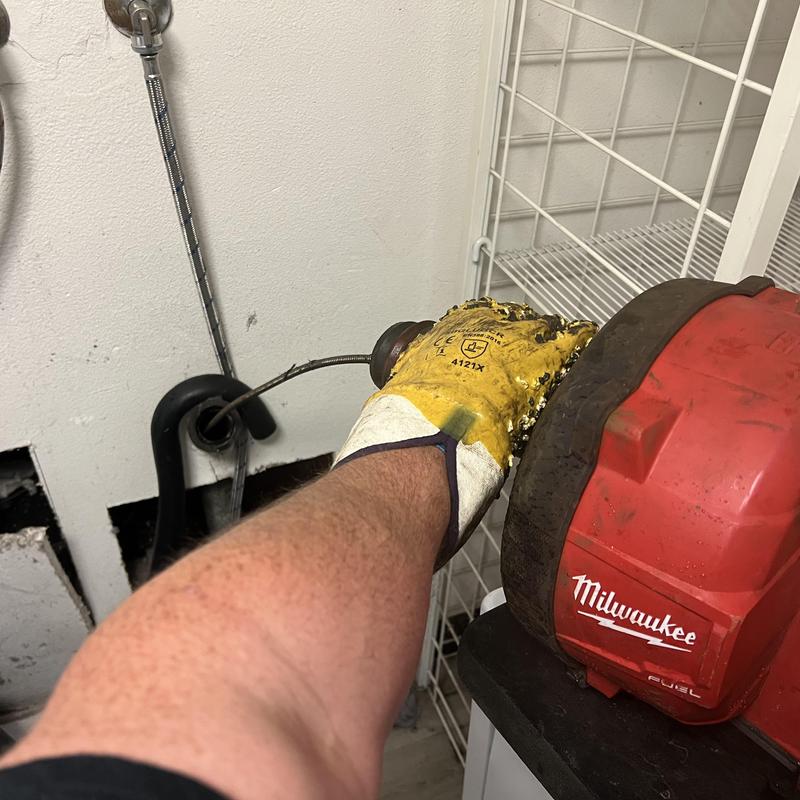 Washing machine drain snaking in laundry room