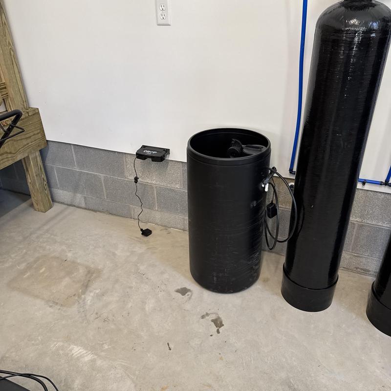 Three-tank water filtration system installation in basement