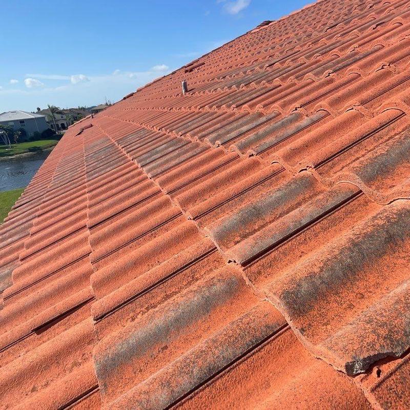 Concrete tile roof showing weathering and minor damage