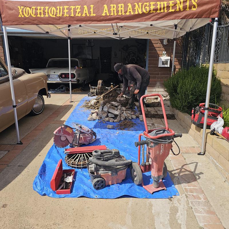 Concrete driveway saw-cut and excavation equipment setup