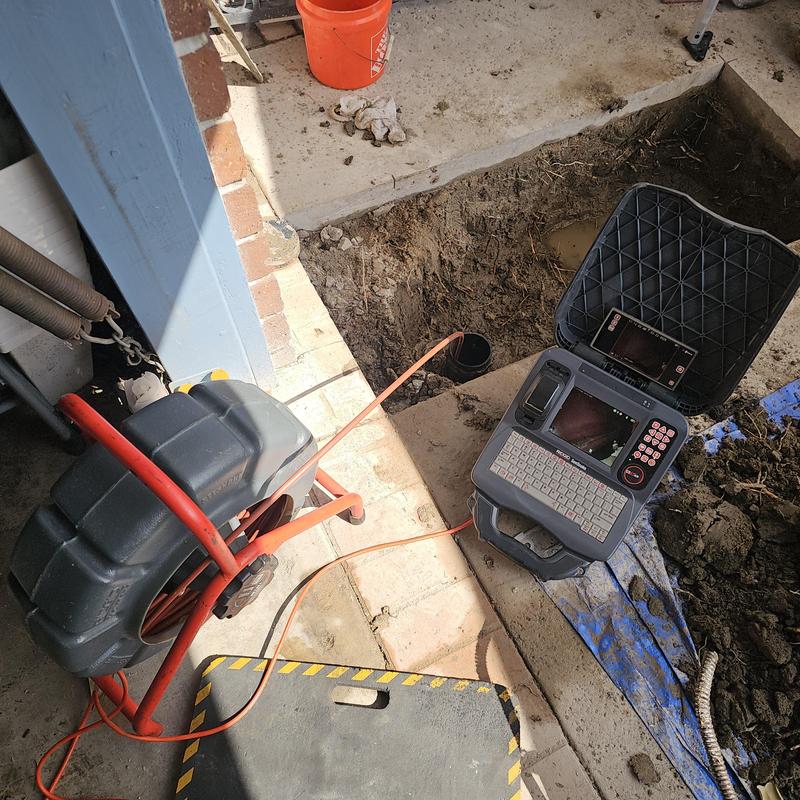 Sewer line inspection camera and excavation at driveway