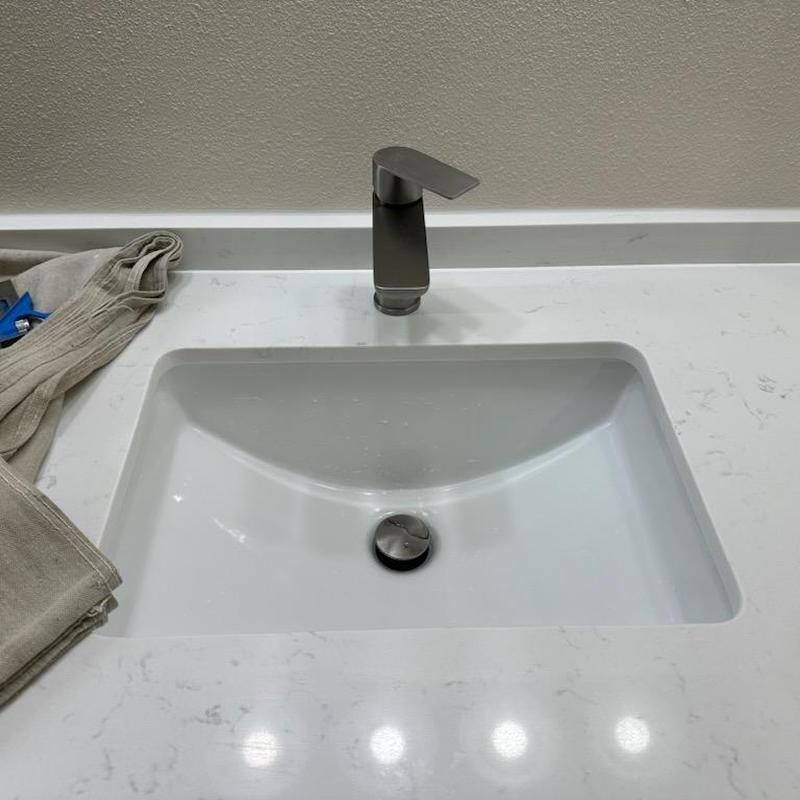 Push-down sink drain stopper in bathroom lavatory sink