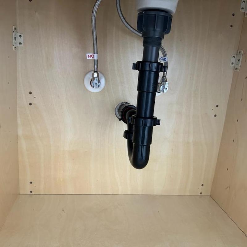 Bathroom sink drain pop-up assembly under cabinet