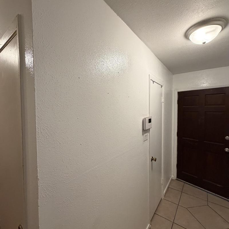 Sheetrock wall with fresh texture and paint near door