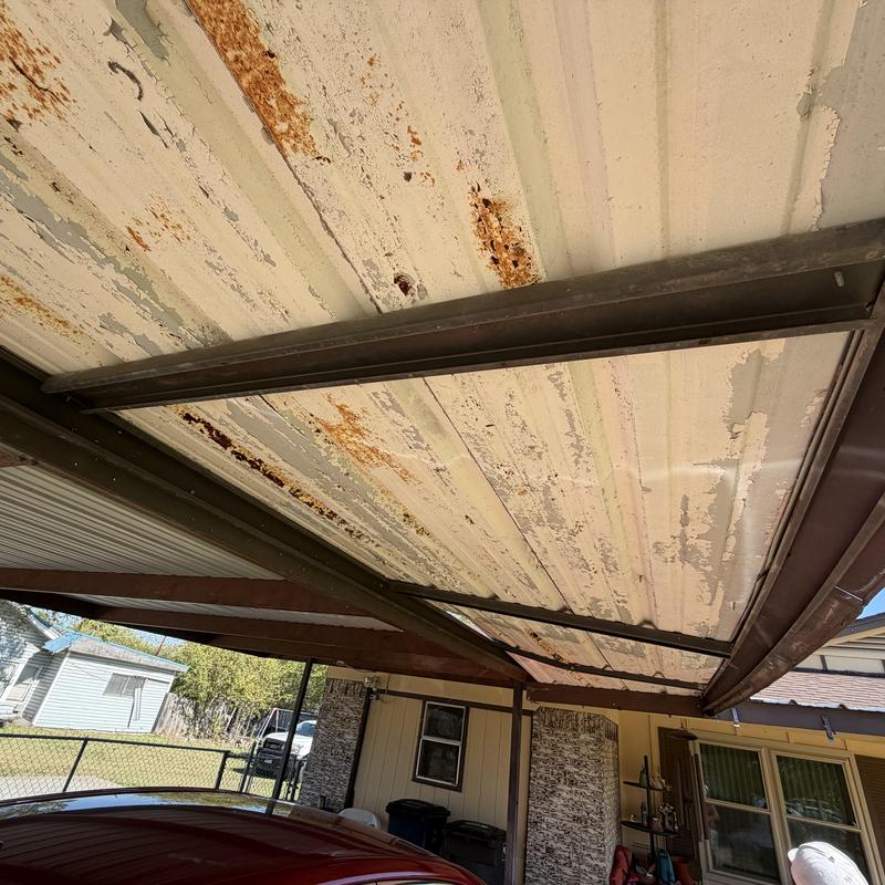 Metal carport ceiling with rust and peeling paint