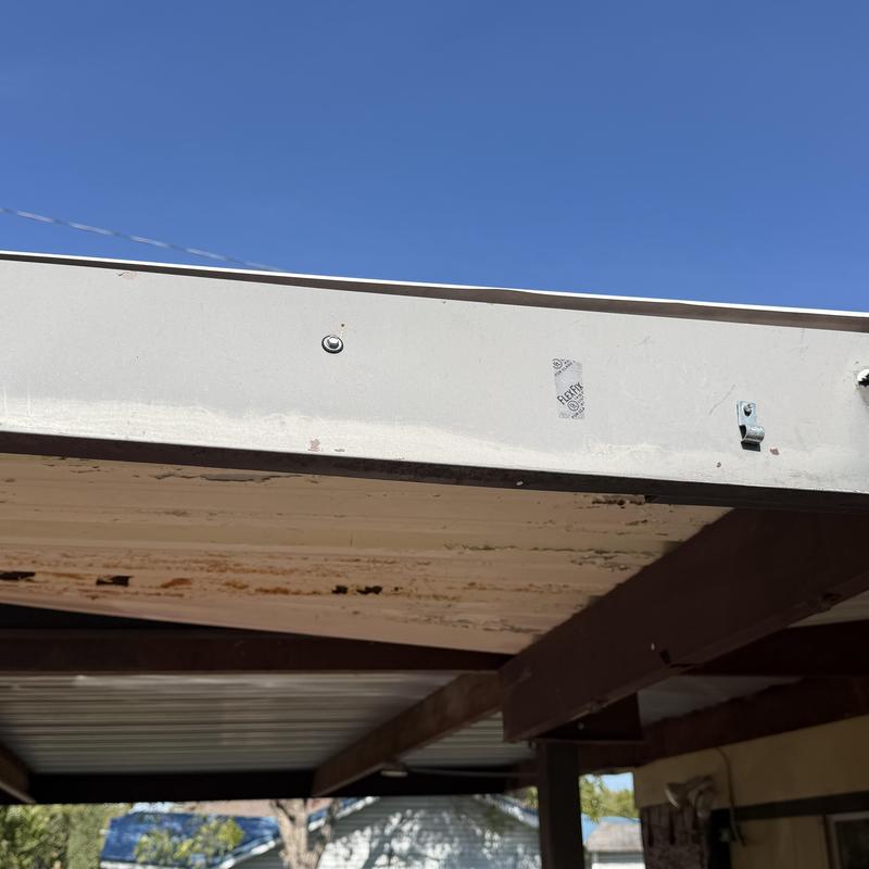 Metal carport roof panels with wind damage detail