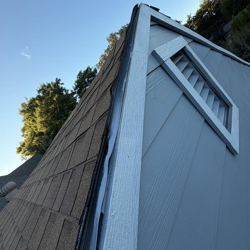 Asphalt shingle roof edge with trim and vent detail