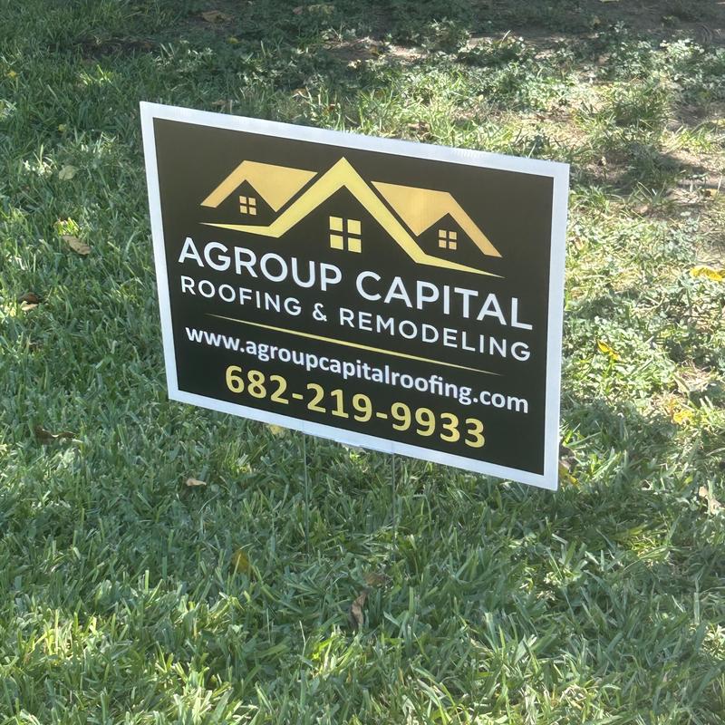 Roofing company yard sign on green grass