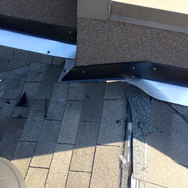 Roof flashing with replaced shingles on apartment roof