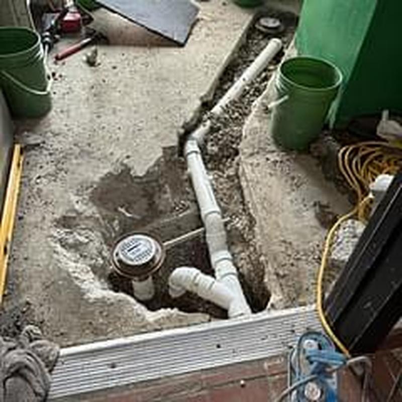 Floor drain installation with PVC piping near door