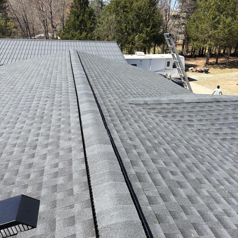 Asphalt shingle roof with new ridge vent installation