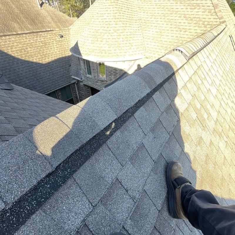 Asphalt shingle ridge vent with inspection boot