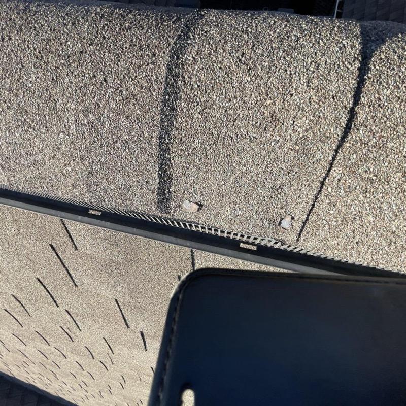 Asphalt shingle roof with exposed fasteners and ridge vent