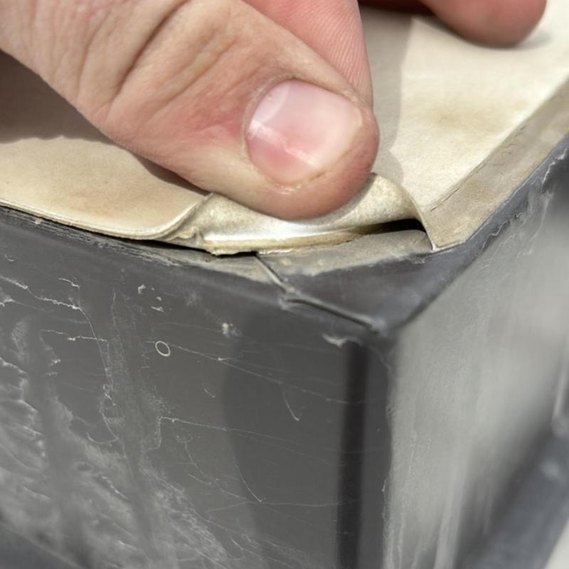 TPO metal roof membrane seam inspection close-up