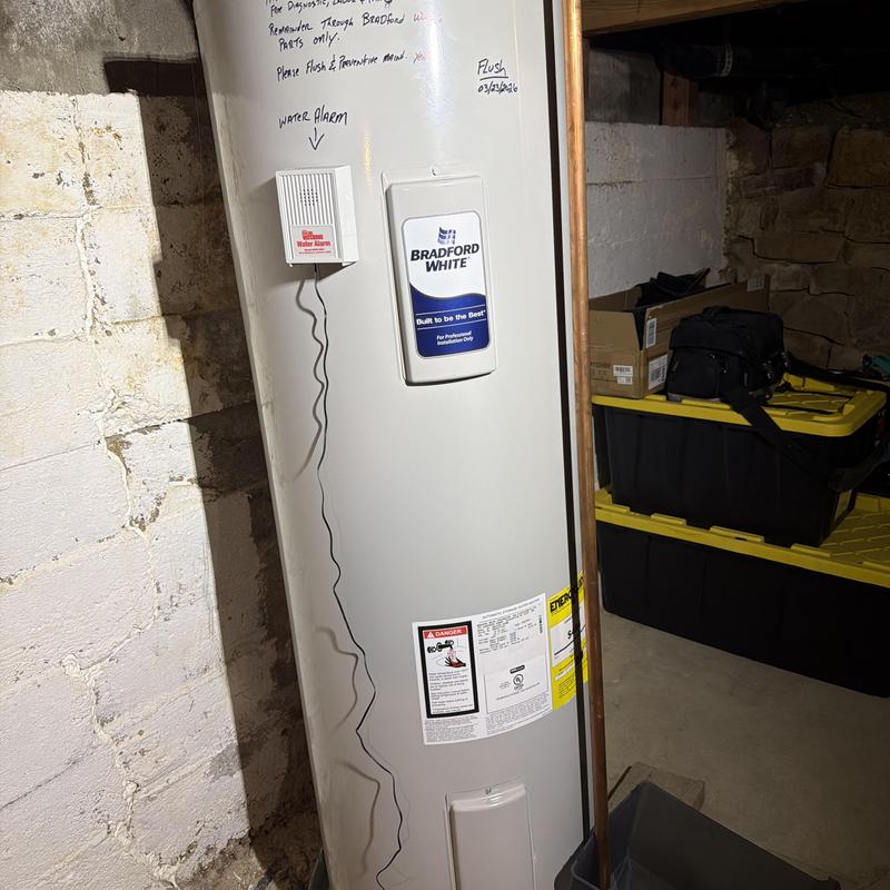 Water heater tank with water alarm and maintenance notes
