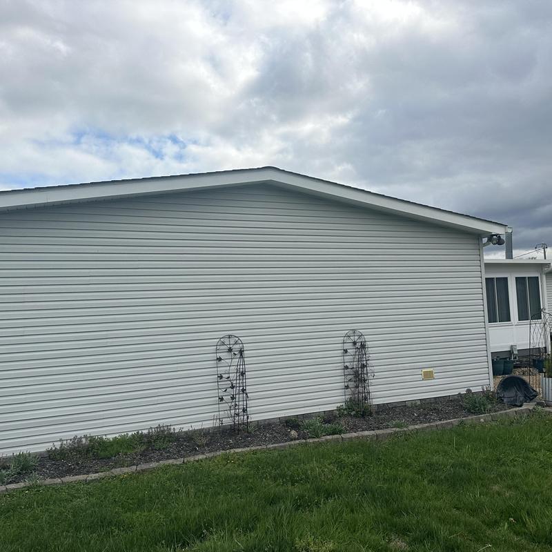 Vinyl siding on residential home exterior under cloudy sky